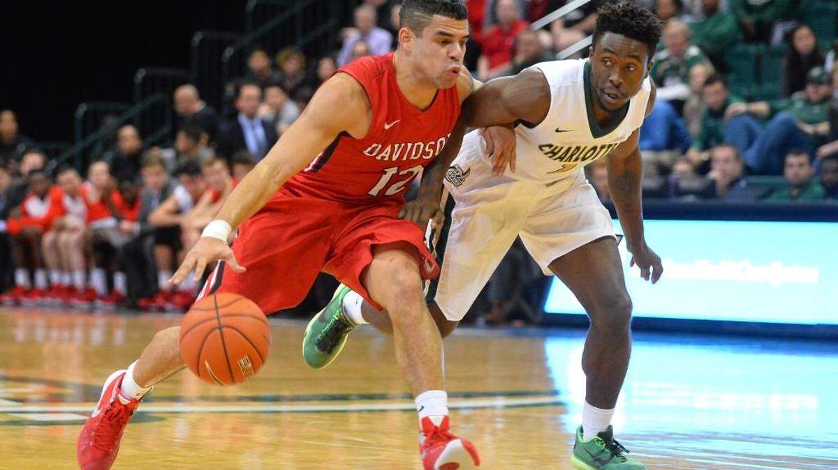 Davidson guard Jack Gibbs (12) breaks past Charlotte's Braxton Ogbueze (1) to score two of his 41 points as the Wildcats take on the 49ers' in the Battle of the Hornets' Nest annual non-conference basketball game at Halton Arena on Tuesday, December 01, 2015 in Charlotte, North Carolina. Gibbs 41 points was a career high as Davidson won 109-74.