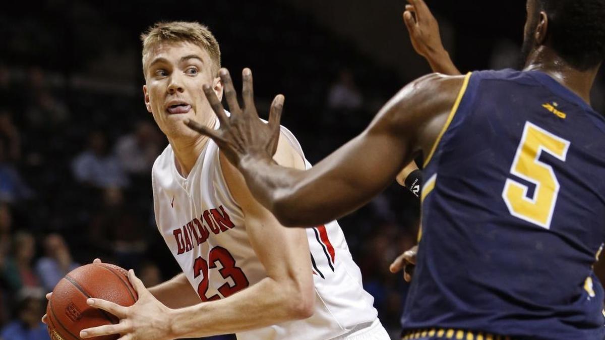 Davidson forward Peyton Aldridge (23) looks to pass around La Salle forward Tony Washington (5) during Thursday’s Atlantic 10 men's tournament game at the Barclays Center in New York.