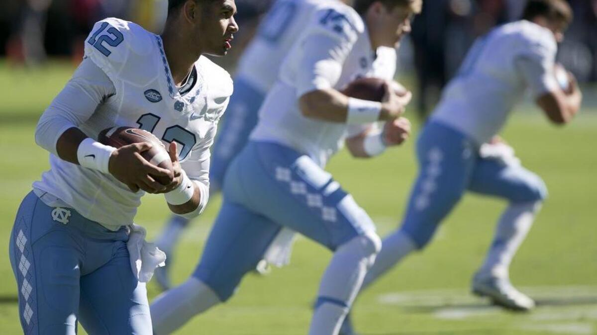 North Carolina redshirt quarterback Chazz Surratt, left, is competing with LSU transfer Brandon Harris to be the Tar Heels’ starter.