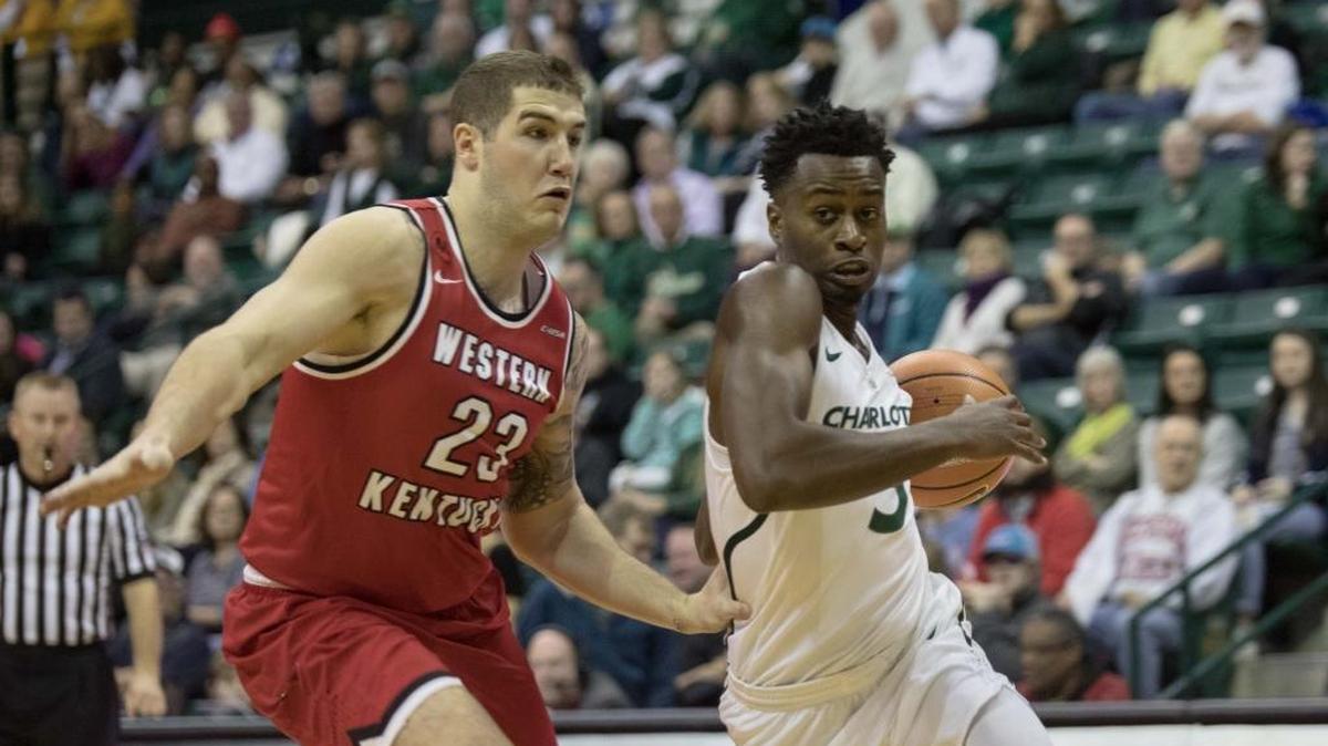 Charlotte 49ers guard Austin Ajukwa, right, drives to the basket against Western Kentucky forward Justin Johnson during Saturday’s Conference USA game at Halton Arena. The 49ers hit just 34.5 percent of their shots in Saturday’s 73-63 loss.