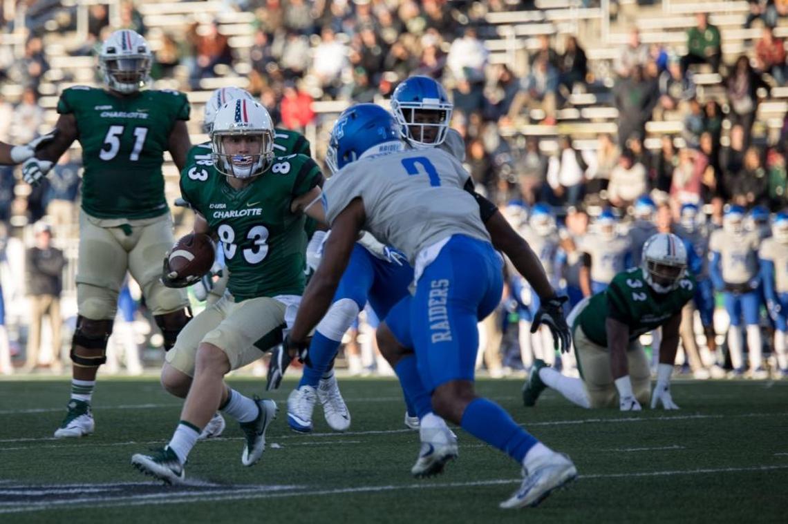 Charlotte 49ers wide receiver Nate Mullen (83) looks for running room as Middle Tennesee safety Jovante Moffatt closes in during Saturday’s game at Richardson Stadium