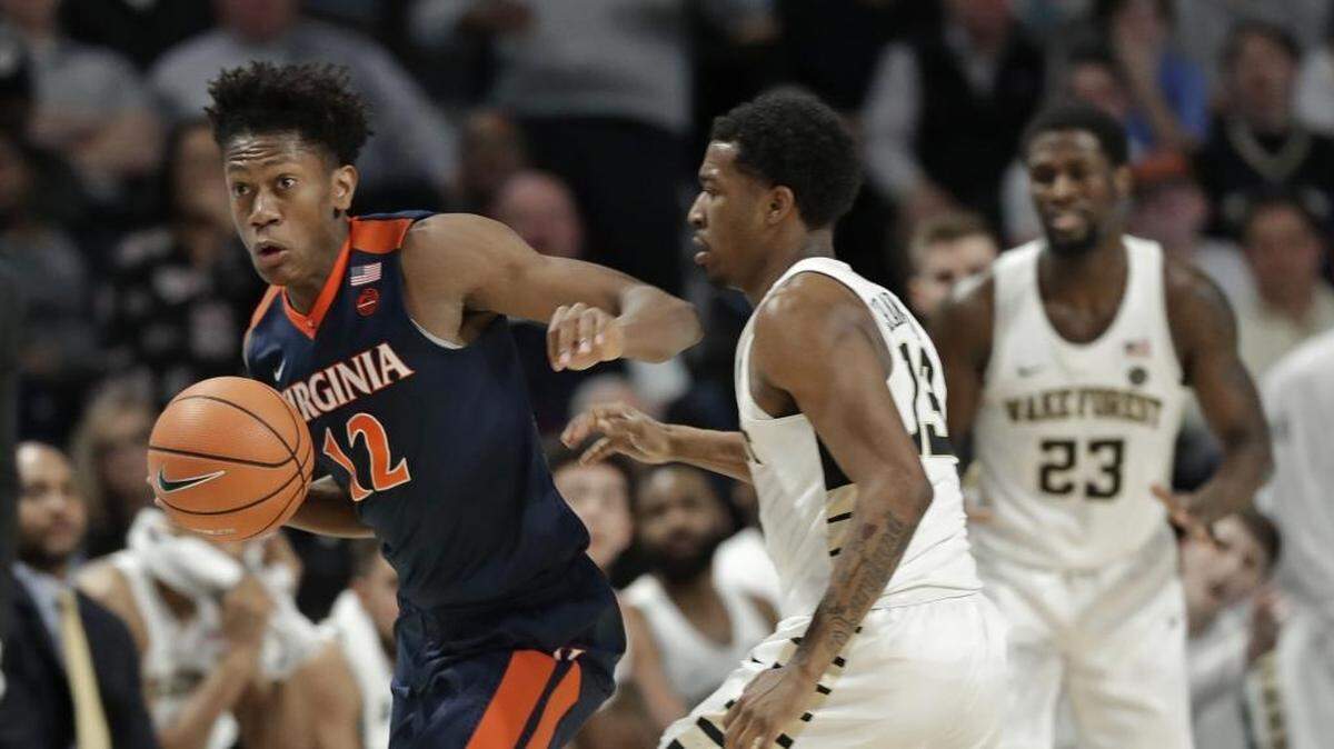 Virginia’s De’Andre Hunter (12) steals the ball from Wake Forest’s Bryant Crawford (13) during the second half of Sunday’s game in Winston-Salem.