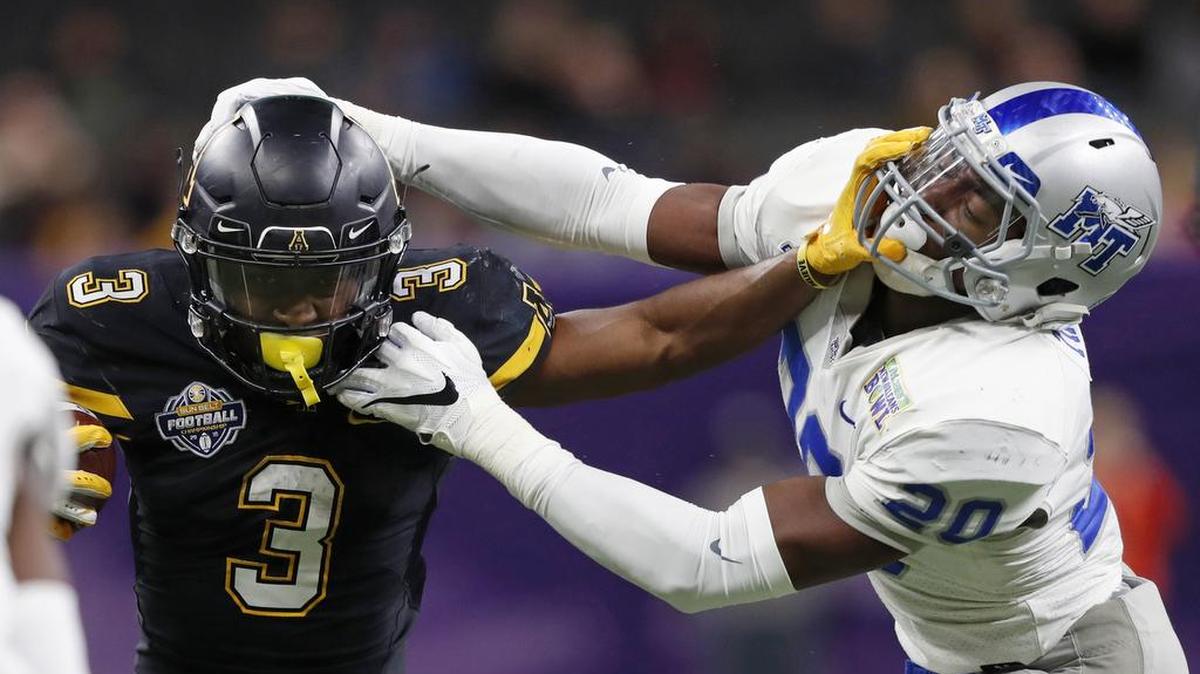 Middle Tennessee linebacker DQ Thomas, right, tries to tackle Appalachian State running back Darrynton Evans in the first half of the New Orleans Bowl Saturday night. Appalachian State won 45-13.