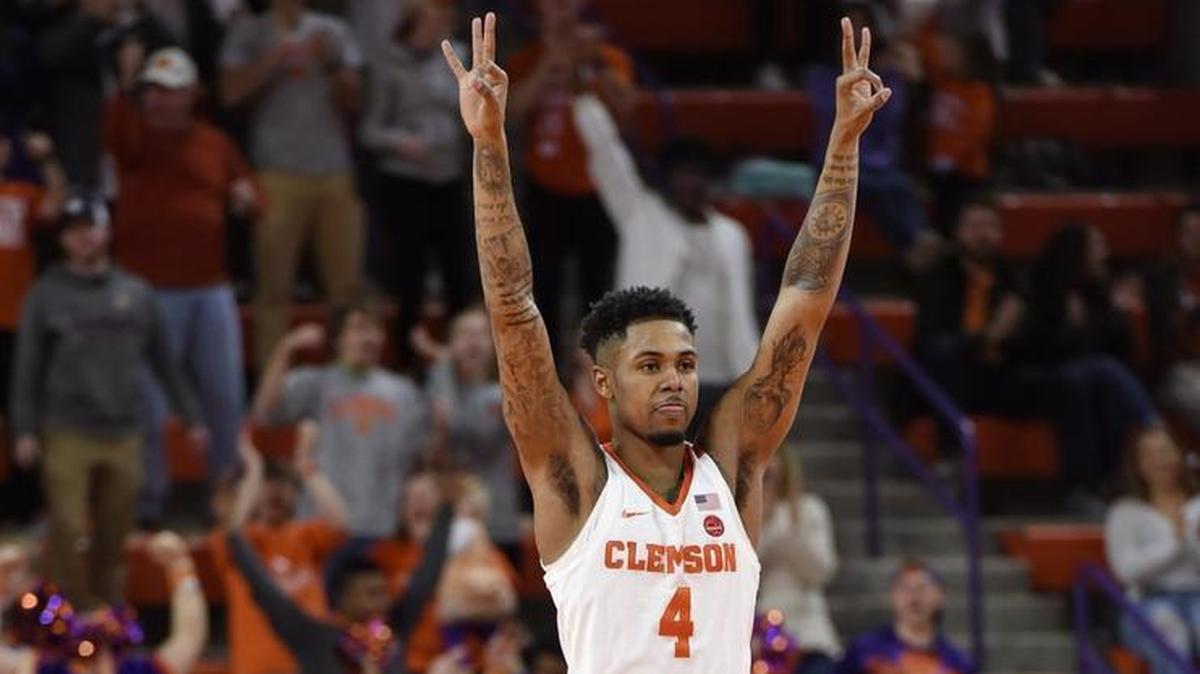 Clemson’s Shelton Mitchell, the former Cuthbertson High star, reacts to a 3-pointer by Gabe DeVoe during overtime of Saturday’s ACC game against Louisville in Clemson. Mitchell and the Tigers won 74-69.