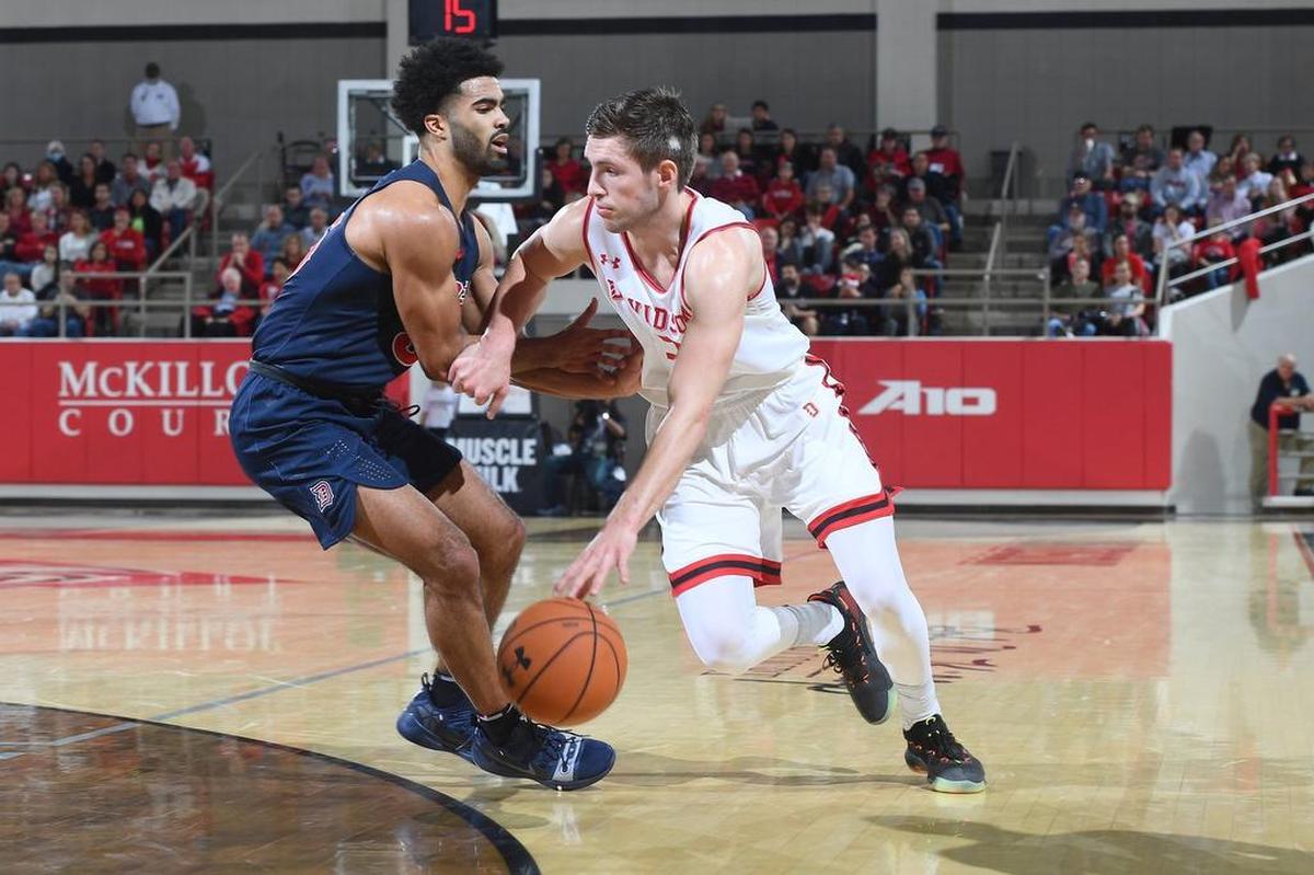 Jon Axel Gudmundsson, right, of Davidson drives to the basket against Duquesne early in the first half of Saturday’s A-10 men's basketball game at Belk Arena. Gudmundsson finished with 12 points as the Wildcats won 65-61.