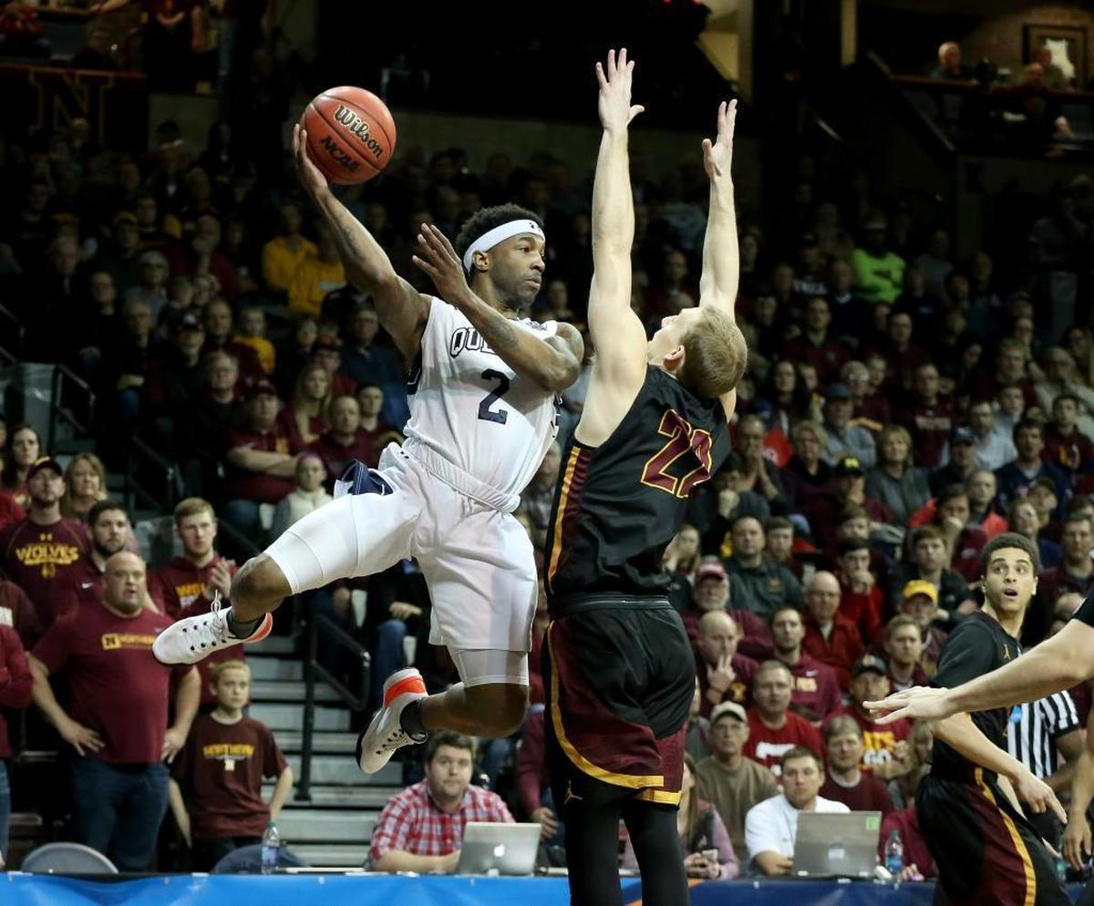 Queens guard Jalin Alexander (2) passes the ball under pressure from Northern State’s Darin Peterka (22) during Thursday night’s NCAA Division II semifinal game.