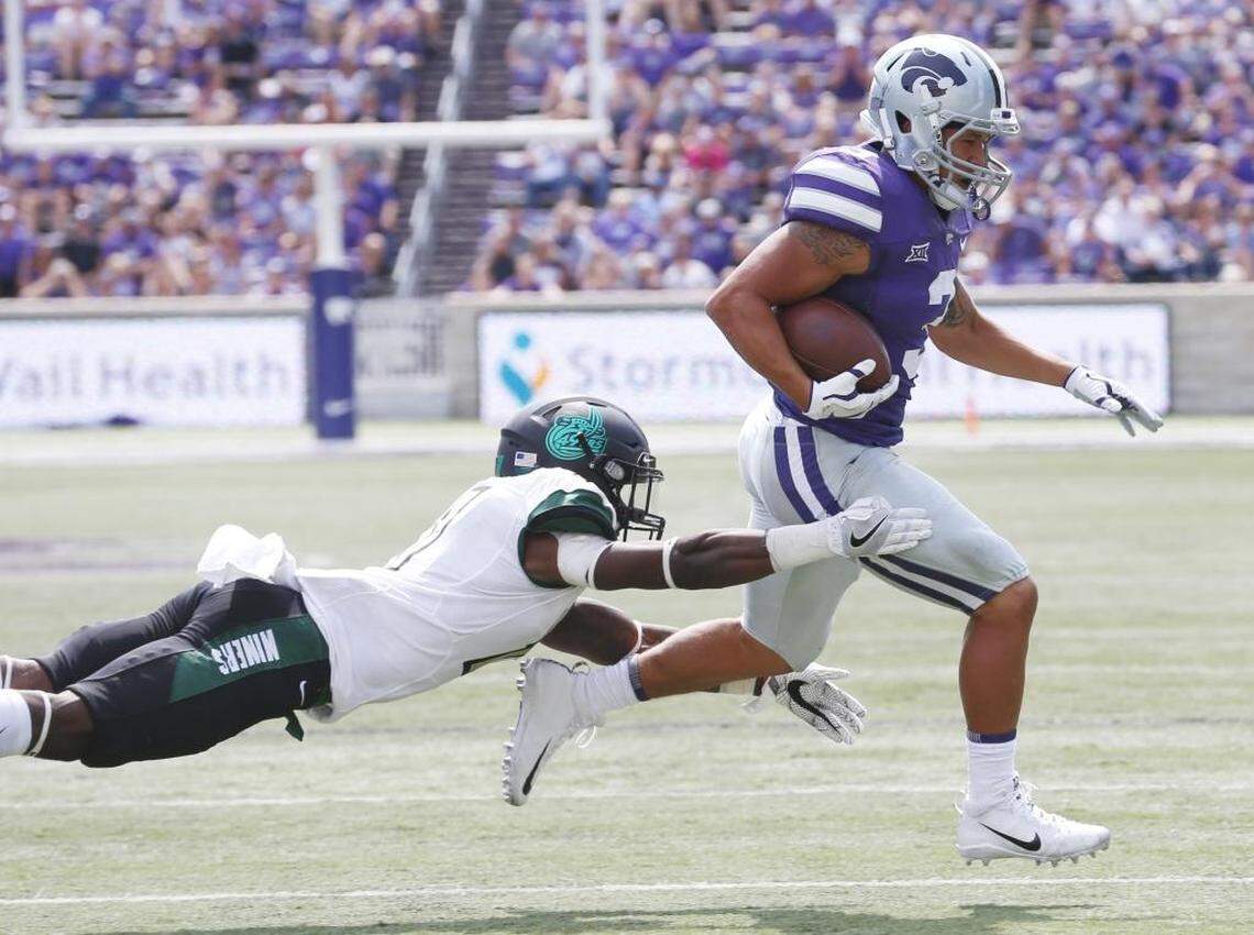 Kansas State runing back Dalvin Warmack (3) slips the grasp of Charlotte defensive back Quinton Jordan in the second half as he scores on a 13-yard run.