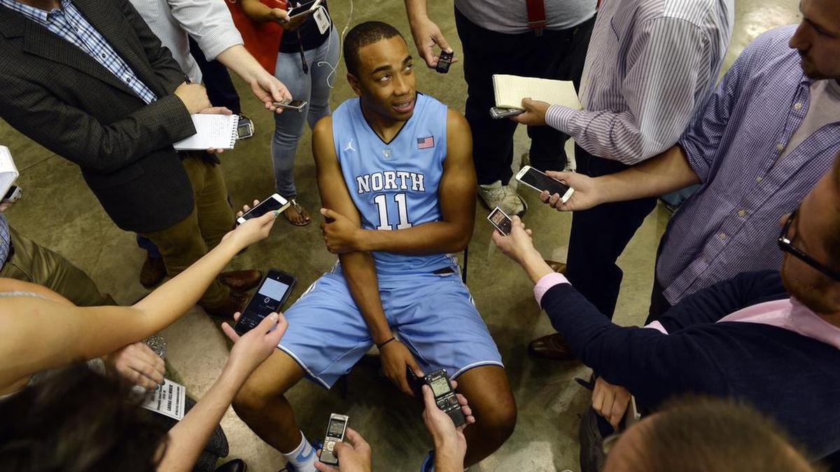 
UNC's Brice Johnson is surrounded by reporters as he does interviews during the University of North Carolina's basketball media day at the Smith Center in Chapel Hill on Monday..
