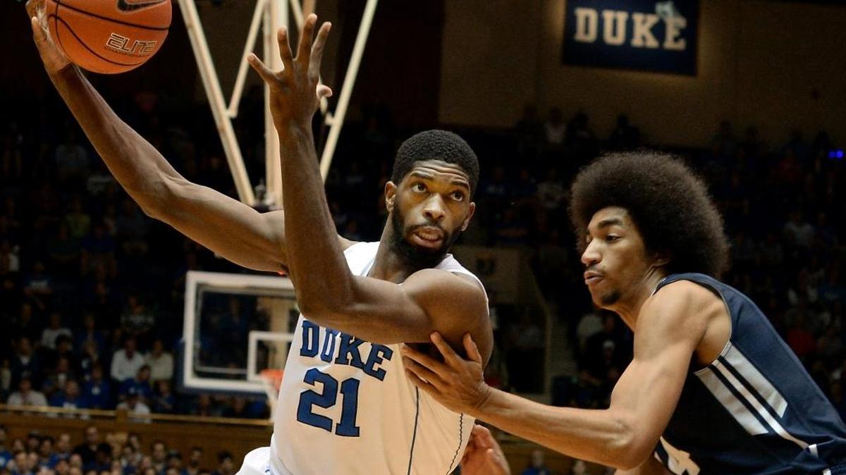 Duke forward Amile Jefferson (21) moves the ball past Utah State forward Jalen Moore (14) in the first half of play as he heads towards the basket. Duke defeated Utah State 85-52 at Cameron Indoor Stadium, Sunday, November 29.
