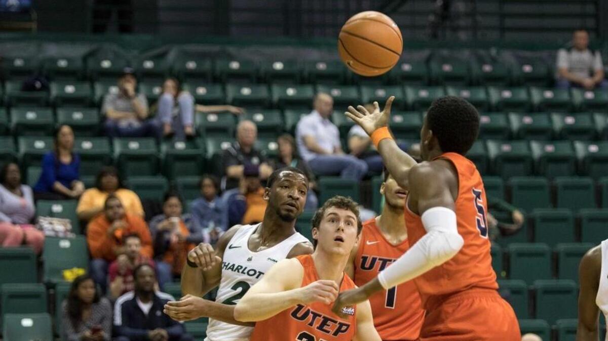 Texas - El Paso’s Trey Wade (5) grabs a rebound as Charlotte 49ers guard Andrien White looks on in the first half of Thursday’s game at Halton Arena.