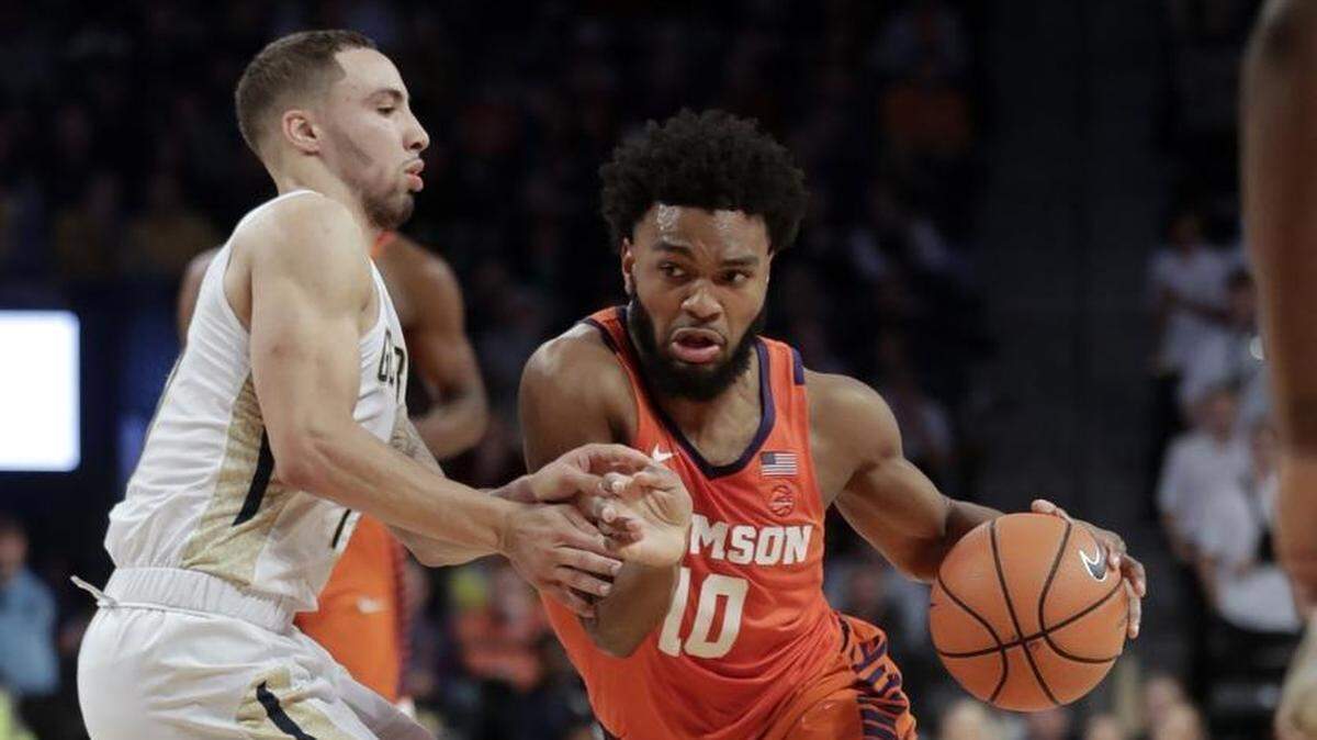 Clemson guard Gabe DeVoe, right, drives against Georgia Tech guard Jose Alvarado, left, in the first half of Sunday’s game in Atlanta. DeVoe scored 25 points as the Tigers squeezed past the Yellow Jackets, 72-70.