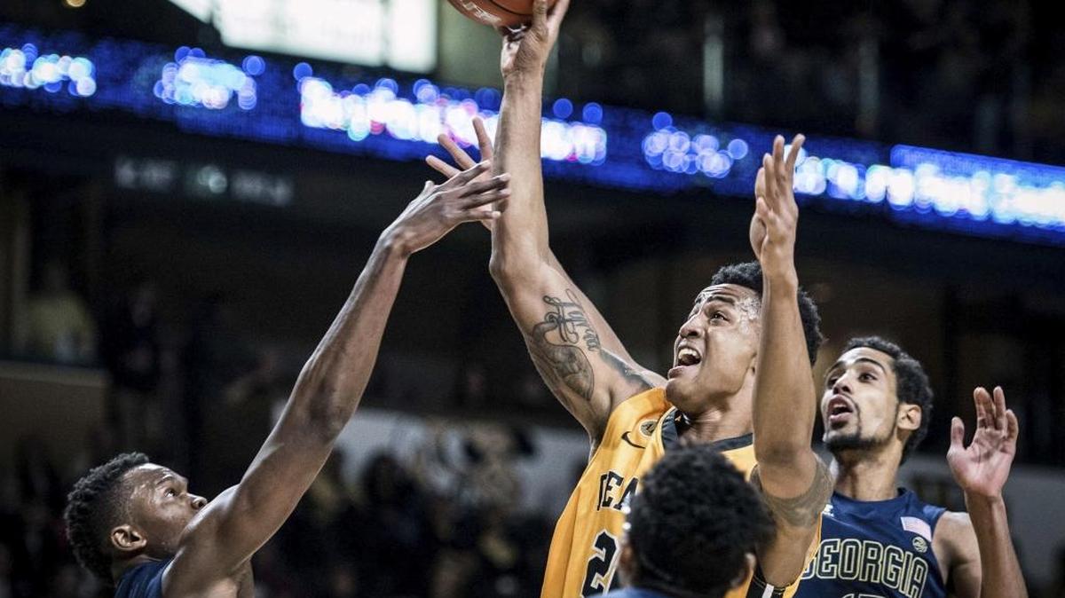 Wake Forest sophomore forward John Collins (center) shoots over Georgia Tech’s Sylvester Ogbonda in Saturday’s ACC game in Winston-Salem. Collins had 20 points, 11 rebounds and five blocked shots in the Deacons’ 81-69 victory.