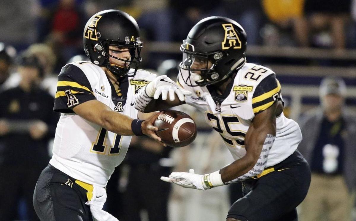 Appalachian State quarterback Taylor Lamb (11) hands the ball to running back Jalin Moore (25) in the first half of the Dollar General Bowl, Saturday, Dec. 23, 2017, in Mobile, Ala.