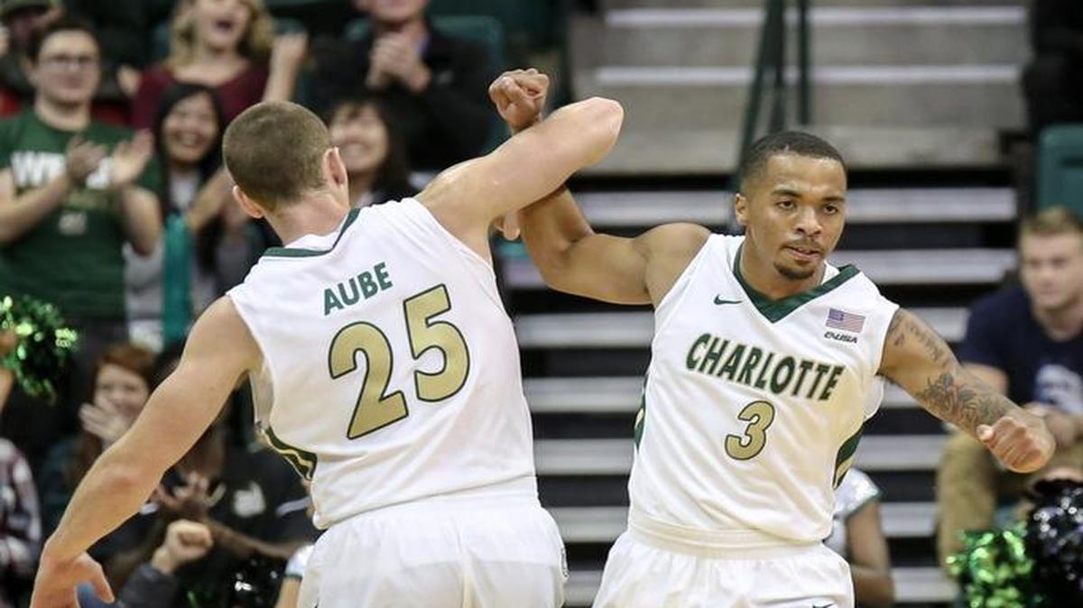 Charlotte 49ers forward Reid Aube (25) and guard Jon Davis celebrate during Friday’s 101-88 win over Newberry. Davis erupted for 24 points in the waning minutes of the game.