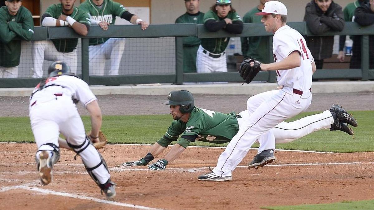 Derek Gallello slides home safely before Winthrop catcher Roger Gonzalez, left, can apply a tag and prevent a run during Charlotte’s 7-1 victory Tuesday at BB&T BallPark.