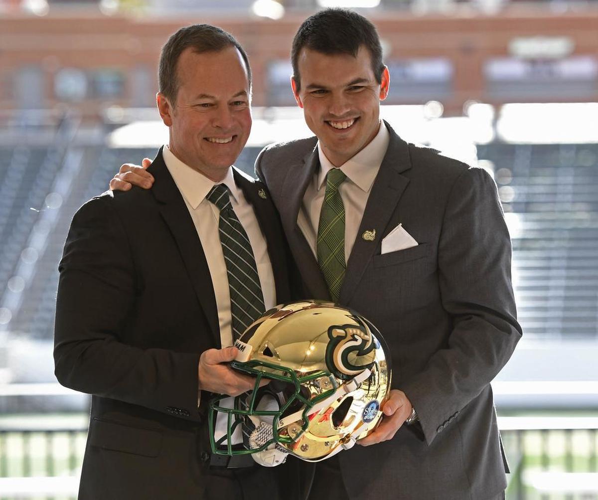 First-year Charlotte 49ers athletics director Mike Hill, left, and new football coach Will Healy pose for a portrait during Healy’s introductory news conference at Richardson Stadium on Wednesday. Healy spent the past three seasons as head coach at Austin Peay.