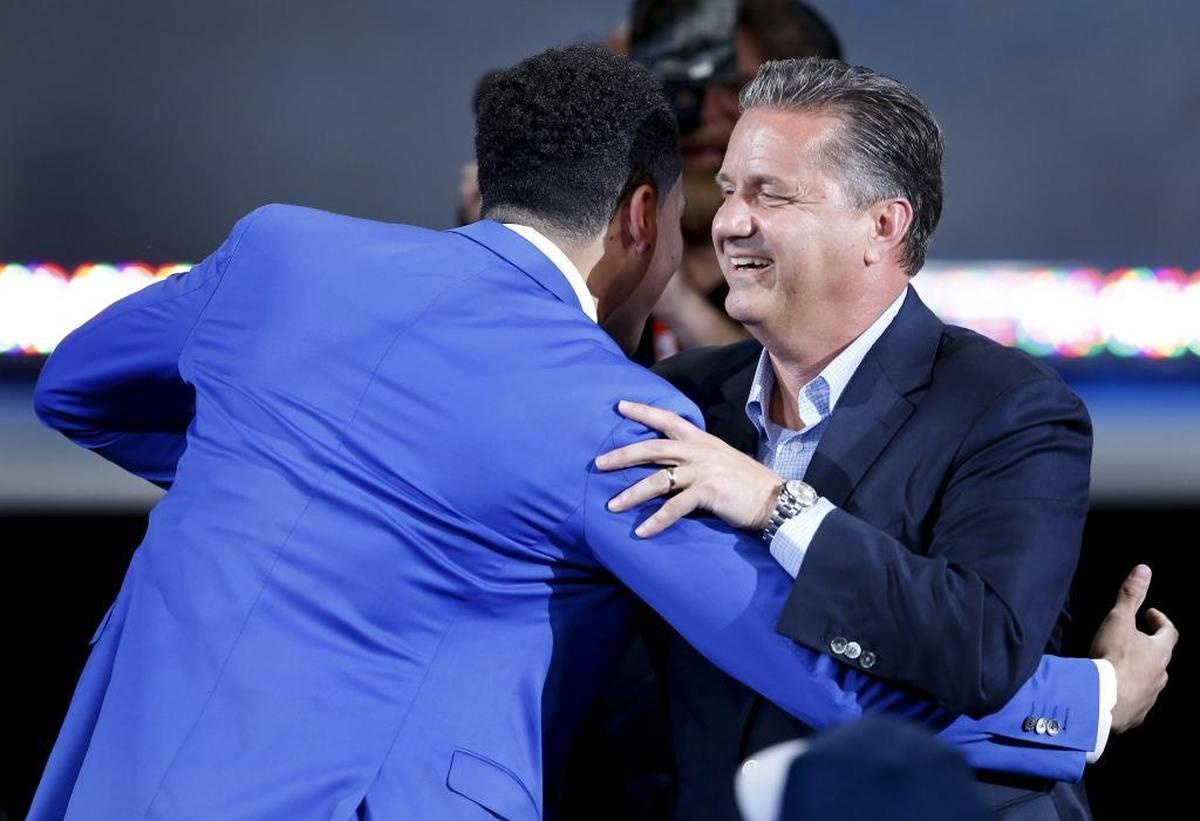 Kentucky coach John Calipari congratulates Devin Booker after Booker was elected 13th overall by the Phoenix Suns during the NBA basketball draft in New York.