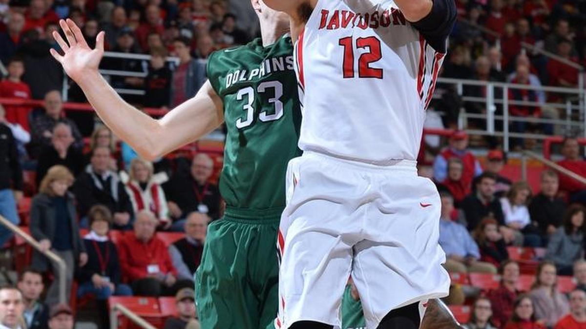 Jack Gibbs of Davidson scores on a layup past Cody Helgeland (33) of Jacksonville during the first half of Wednesday night’s game at Belk Arena in Davidson.