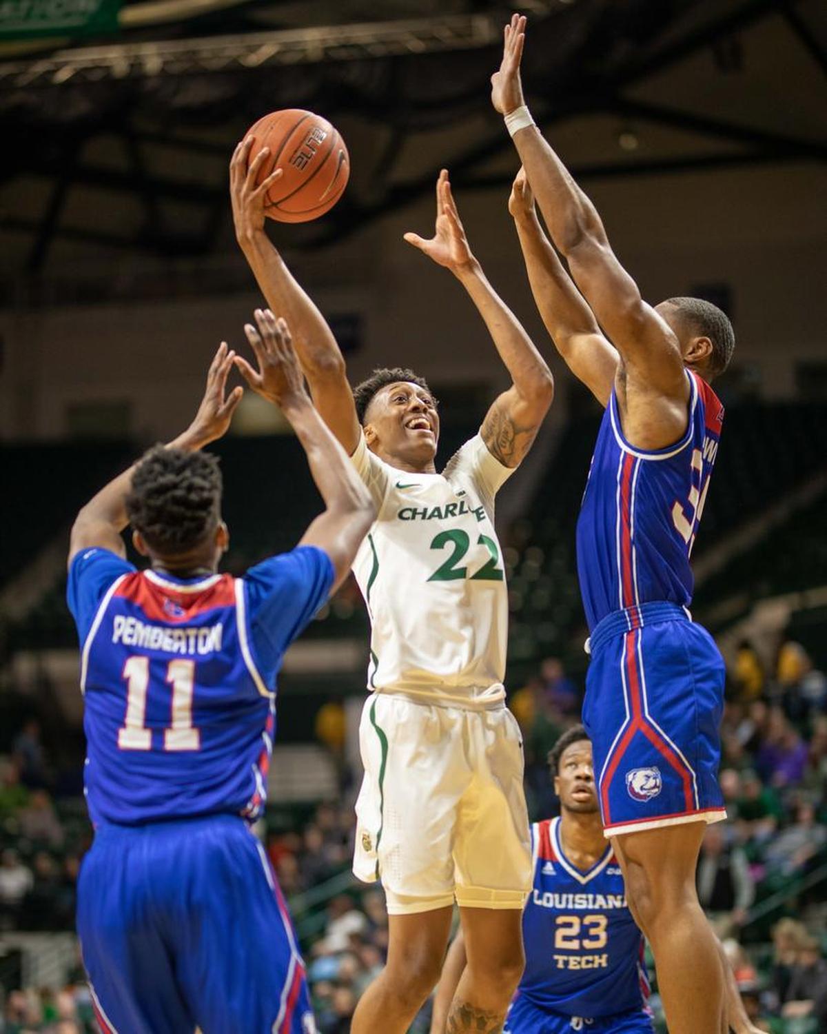 Charlotte 49ers freshman guard Brandon Younger, center, is defended by Louisiana Tech’s Jacolby Pemberton, left, and Oliver Powell in Saturday’s Conference USA men’s basketball game at Halton Arena. Younger finished with five points and seven rebounds in the 49ers’ 55-40 win.