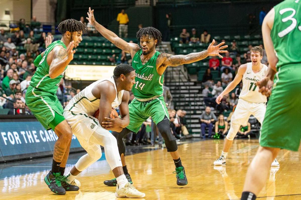 Charlotte 49ers sophomore guard Jaylan McGill is caught in Marshall’s half-court trap by the Thundering Herd’s C.J. Burks, right, and Rondale Watson during Saturday’s Conference USA men’s basketball game at Halton Arena.