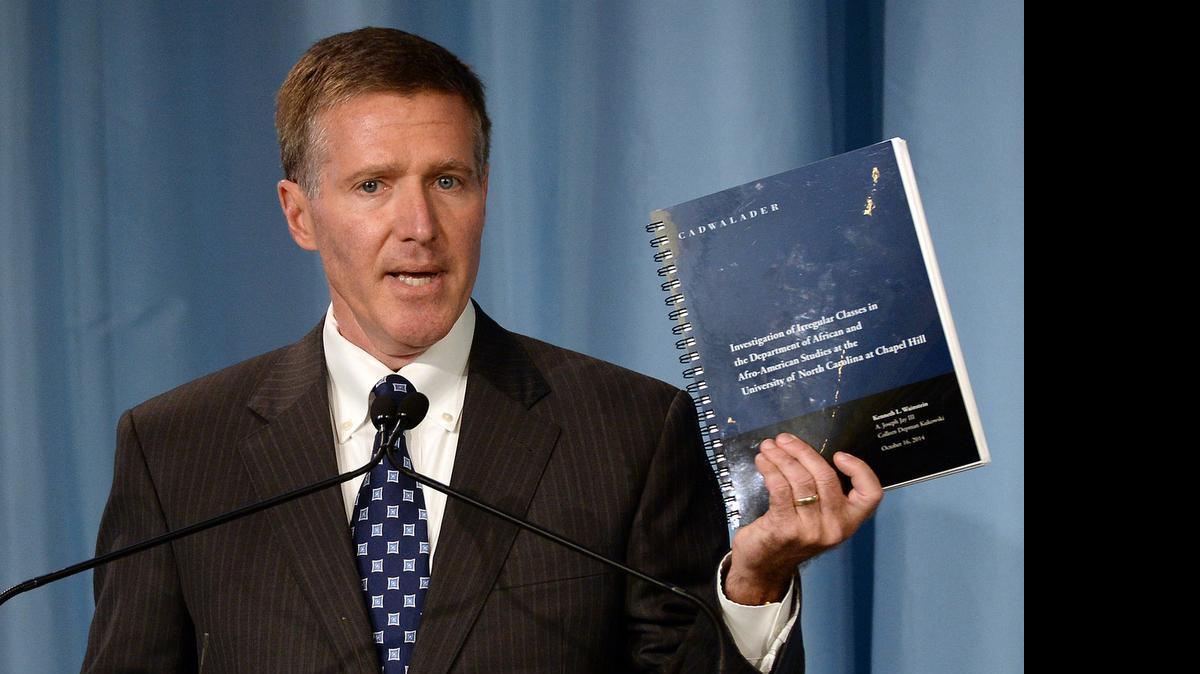 
Kenneth Wainstein, a partner with Cadwalader, Wickersham & Taft LLP, holds up a report detailing accounts of academic fraud in association with the athletic department at UNC during a press conference on Oct. 22, 2014, in Chapel Hill.
