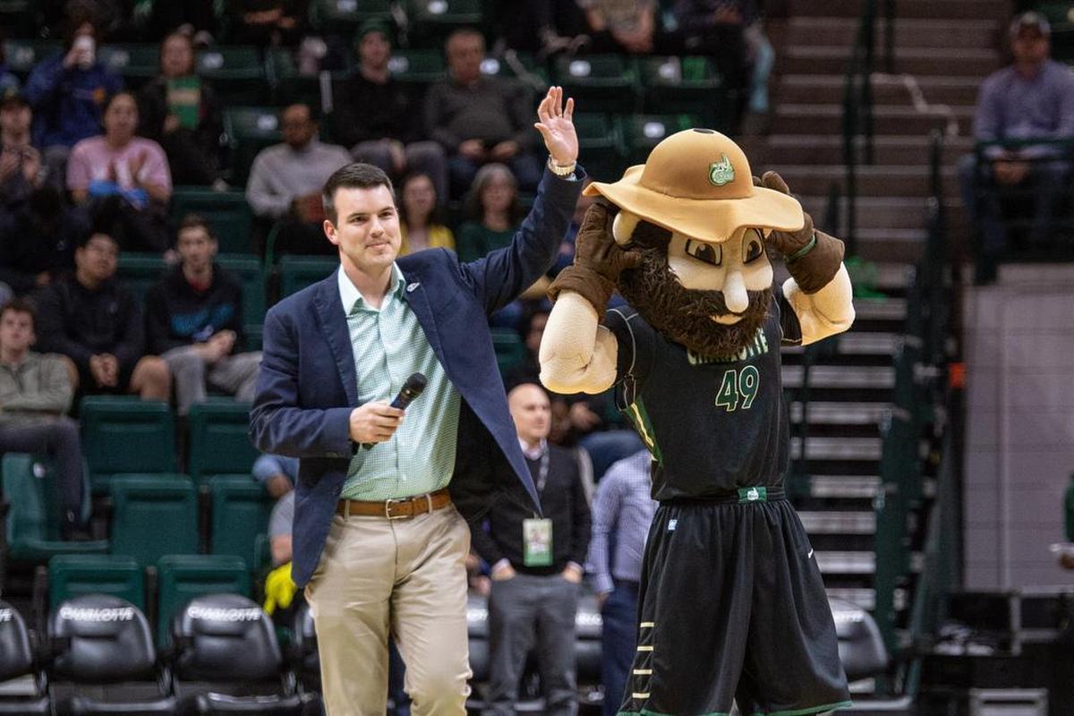 Charlotte football head coach Will Healy addresses a 49ers crowd at a basketball game in January.