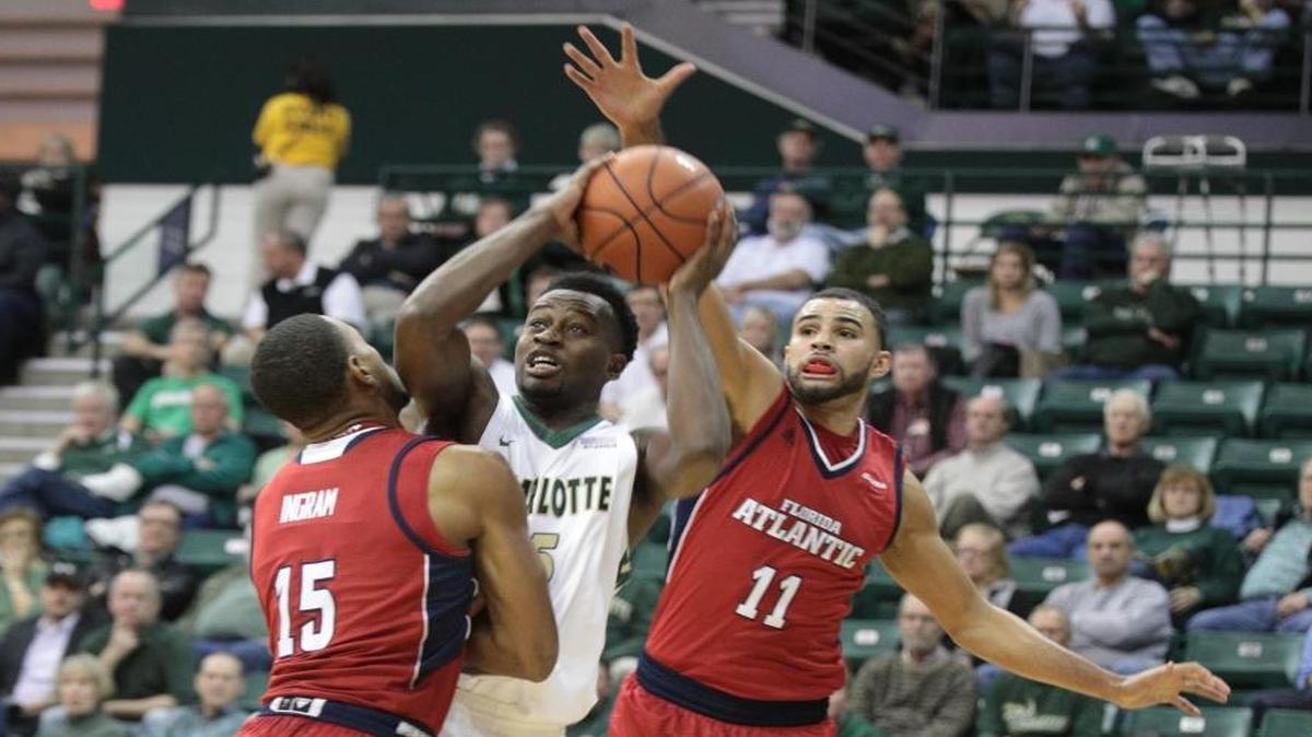 Charlotte 49ers guard Austin Ajukwa, center, looks for a shot as Florida Atlantic’s Jailyn Ingram and Frank Booker defend in Thursday’s game at Halton Arena.