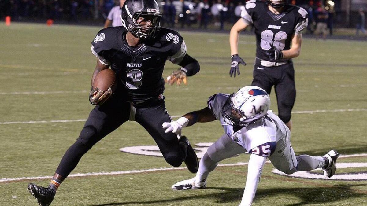 Before heading off to play football at Tennessee, Marquill Osborne, left, was a standout at Hough High School. He will play next season for the Charlotte 49ers.