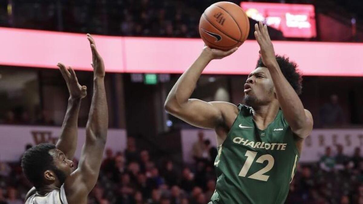 Charlotte 49ers freshman Malik Martin shoots over Wake Forest's Ikenna Smart in the second half of Thursday’s college basketball game in Winston-Salem. Wake Forest won 80-56.