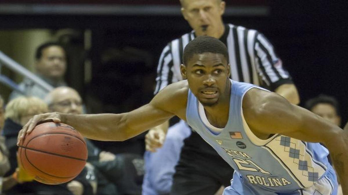 North Carolina guard Seventh Woods, left, brings the basketball up court as Hawaii guard Brocke Stepteau (2) looks on during the second half of Friday’s game in Honolulu. North Carolina beat Hawaii 83-68.