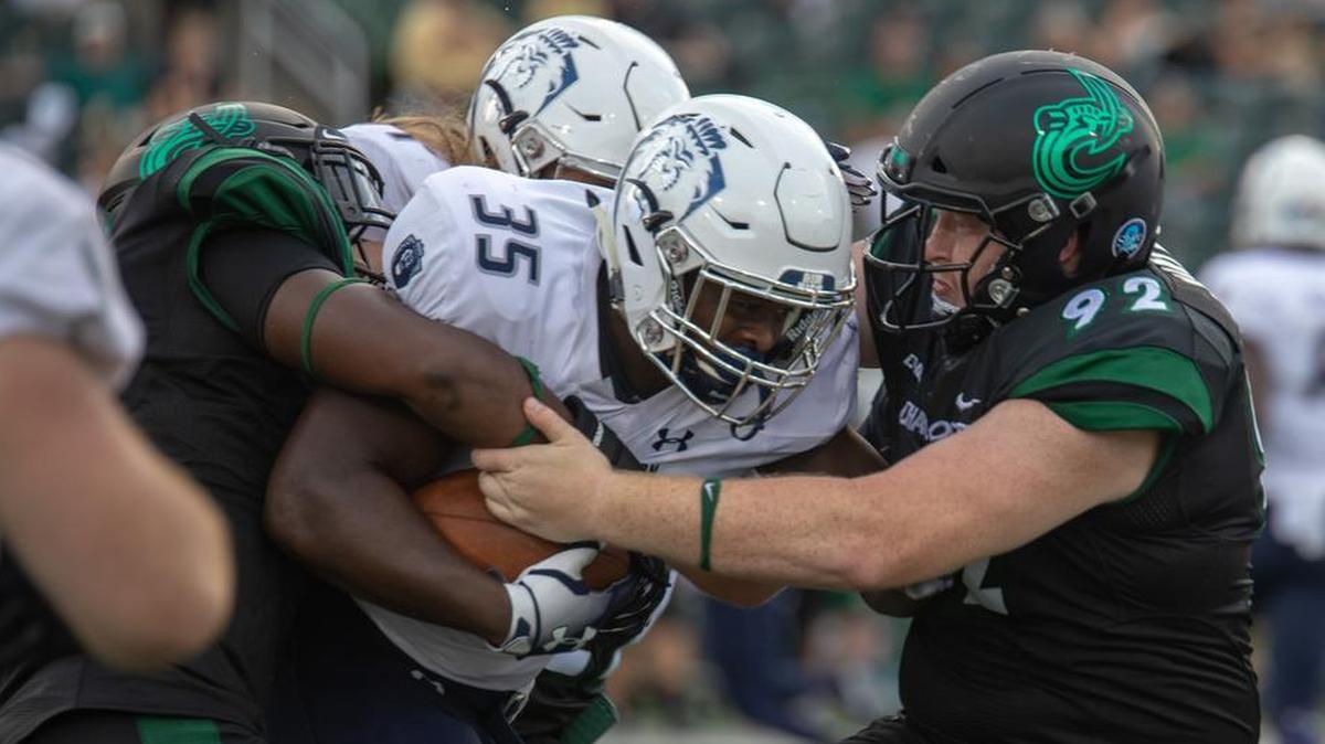 Charlotte 49ers defenders Anthony Butler (left) and Nick Martin (right) bring down Old Dominion running back Jermey Cox in Thursday’s Conference USA opener at Richardson Stadium. Charlotte won 28-25.