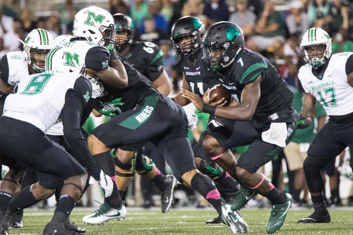 Charlotte 49ers quarterback Hasaan Klugh (7) tries to gain some yardage on a keeper in Saturday’s 14-3 loss to the Marshall Thundering Herd at Richardson Stadium.