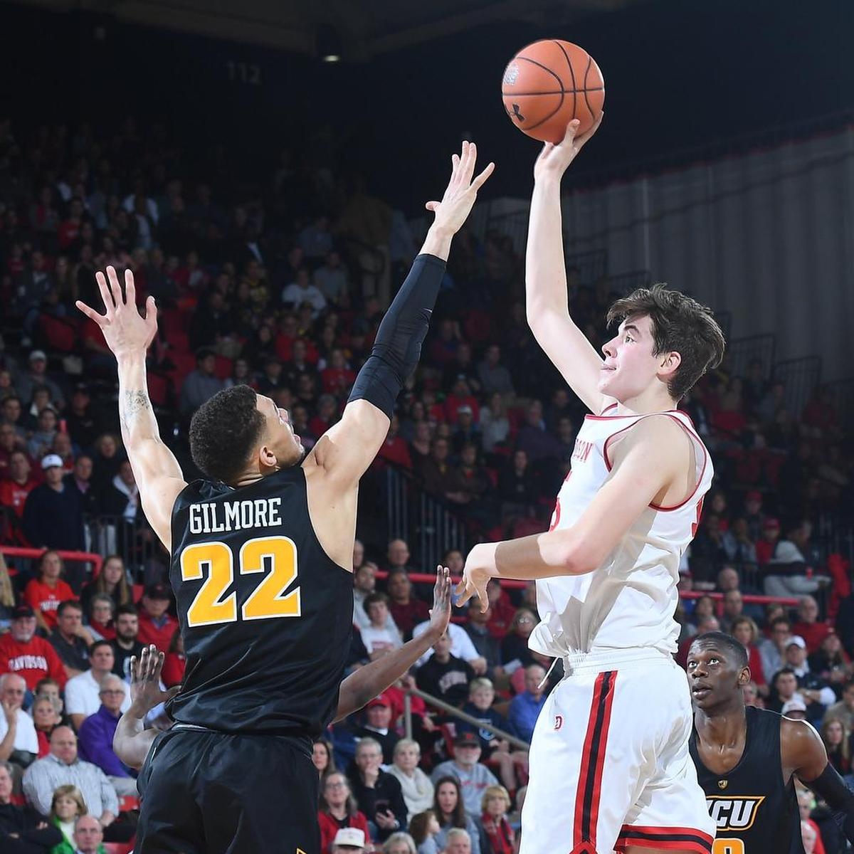 Davidson freshman Luka Brajkovic, right, drops a hook shot over VCU’s Michael Gilmore late in the first half of Saturday’s Atlantic 10 men’s basketball game at Belk Arena. Brajkovic finished with 14 points in Davidson’s 64-57 victory.
