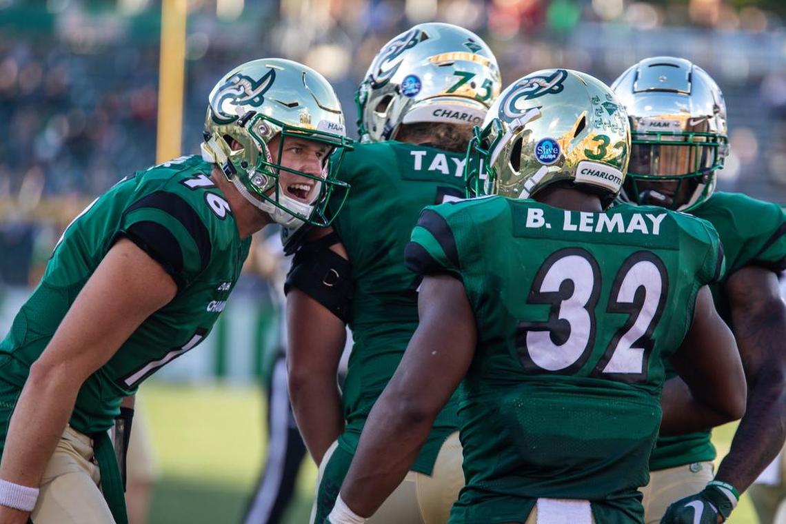 Charlotte 49ers quarterback Evan Shirreffs, left, and Benny LeMay celebrate the running back’s second rushing touchdown against Western Kentucky on Saturday at Richardson Stadium.