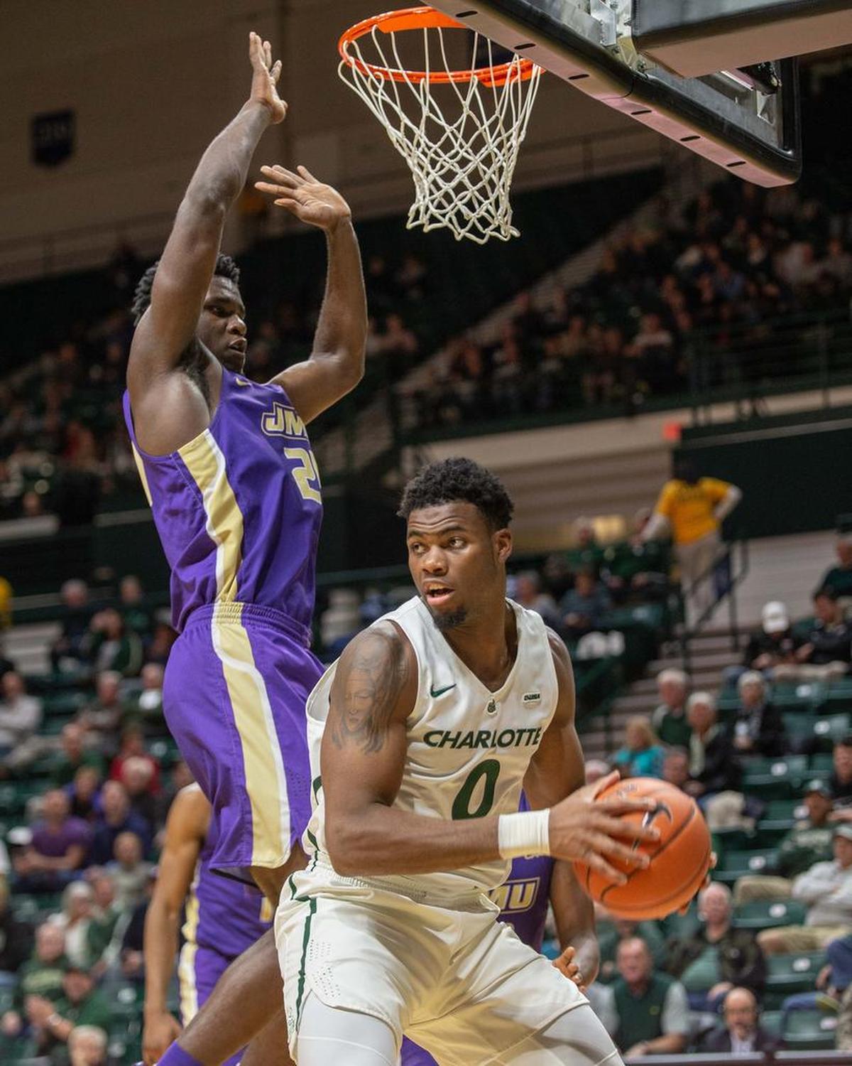 Charlotte 49ers’ Jailan Haslem, right, grabs an offensive rebound against James Madison’s Friday night at Halton Arena. James Madison won 64-59 in the nonconference game.