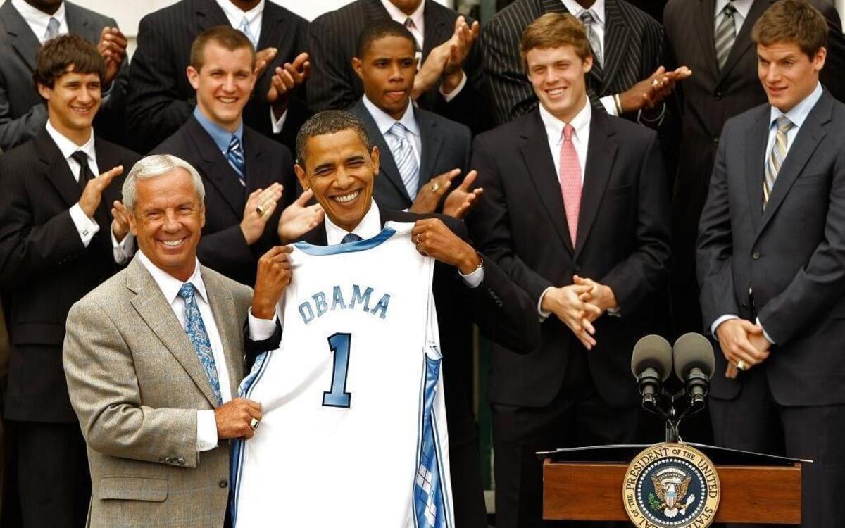 In this 2009 photo, UNC men’s basketball head coach Roy Williams presents President Barack Obama with a team jersey at the White House. The Tar Heels were 2009 national champions. A basketball fan, Obama picked the Tar Heels to win in his March Madness bracket that year.