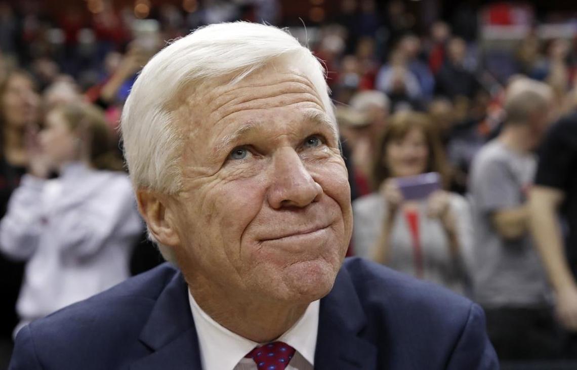 Davidson head coach Bob McKillop pauses on the bench and watches his team celebrate after Sunday’s Atlantic 10 Conference tournament championship win against No. 25 Rhode Island.