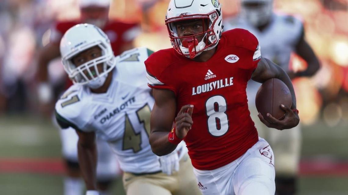 Louisville quarterback Lamar Jackson races to the end zone for a touchdown as the Charlotte 49ers’ AJ McDonald gives chase in Thursday night’s game at Papa John’s Cardinal Stadium in Louisville.