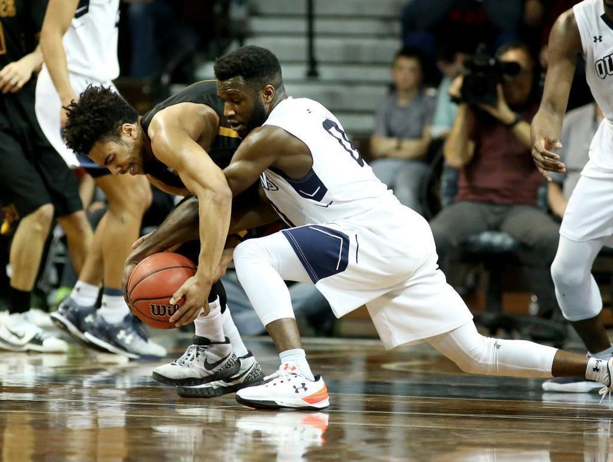 Queens point guard Ike Agusi, right, battles for the ball with Northern State’s Ian Smith during Thursday night’s semifinal game in the NCAA Division II Men's Basketball Championship tournament at the Sanford Pentagon in Sioux Falls, South Dakota. The Royals fell 105-99 in two overtimes.
