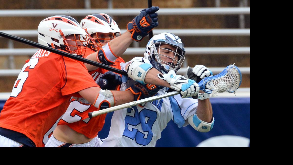 
UNC's Steve Pontrello (29) crashes through Virginia defenders Tanner Scales (6) and Scott McWilliams (27) during the 2013 ACC Lacrosse Championship game in Chapel Hill on April 28, 2013. 
