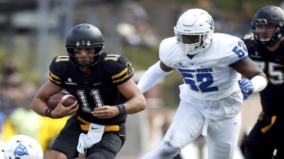Appalachian State quarterback Taylor Lamb (11) evades Georgia State safety Bryan Williams (20), safety Bobby Baker (2) and defensive end Tevin Jones (52) during the third quarter of Saturday’s Sun Belt Conference game in Boone.