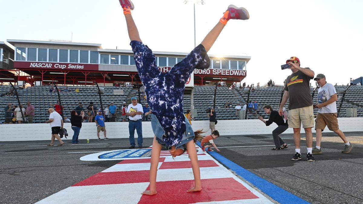 Chloee Dean, 11 years old, does a round off at the start/finish line at North Wilkesboro Speedway on Wednesday, May 10, 2023. The speedway held an open house for fans to see the new renovations to the track. North Wilkesboro Speedway will host the NASCAR All-Star race on Sunday, May 21, 2023. The last race ran at the speedway was in 1996.