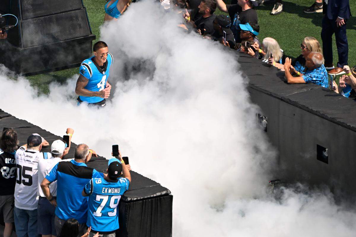 Carolina Panthers wide receiver Tetairoa McMillan (4) runs on to the field before Sunday’s game against the Atlanta Falcons at Bank of America Stadium.