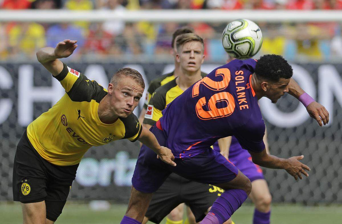 Borussia Dortmund's Amos Pieper, left, battles Liverpool's Dominic Solanke (29) during the second half of an International Champions Cup tournament soccer match in Charlotte, N.C., Sunday, July 22, 2018. (AP Photo/Chuck Burton)