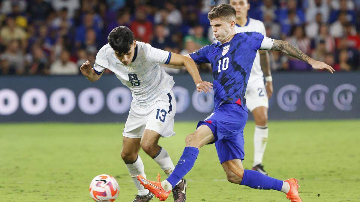 Mar 27, 2023; Orlando, Florida, USA; El Salvador midfielder Leonardo Menjívar (13) and United States of America forward Christian Pulisic (10) during the second half at Exploria Stadium. Mandatory Credit: Reinhold Matay-USA TODAY Sports