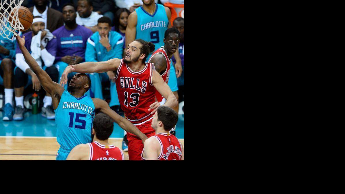 
Charlotte Hornets guard Kemba Walker (15) drives to the basket for a shot attempt as Chicago Bulls center/forward Joakim Noah (13) on Friday March 13, 2015 at Time Warner Cable Arena in Charlotte.
