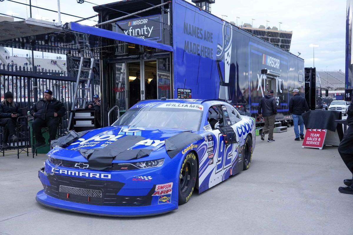 Mar 18, 2023; Hampton, Georgia, USA; NASCAR Xfinity Series driver Josh Williams (92) sits next to the Xfinity hauler after Williams abandon it on the track at Atlanta Motor Speedway. Mandatory Credit: David Yeazell-USA TODAY Sports
