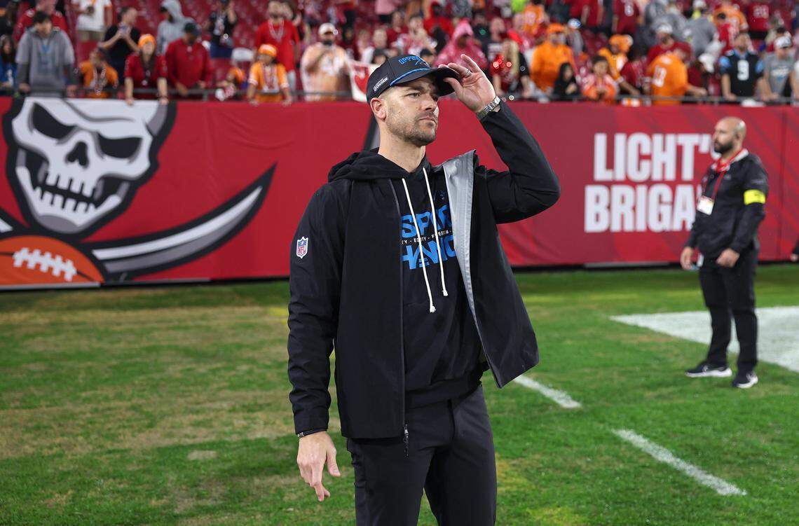 Carolina Panthers head coach Dave Canales waits along a sideline to embrace his players following the team’s 16-14 loss to the Tampa Bay Buccaneers at Raymond James Stadium in Tampa, FL.on Saturday, January 3, 2026.