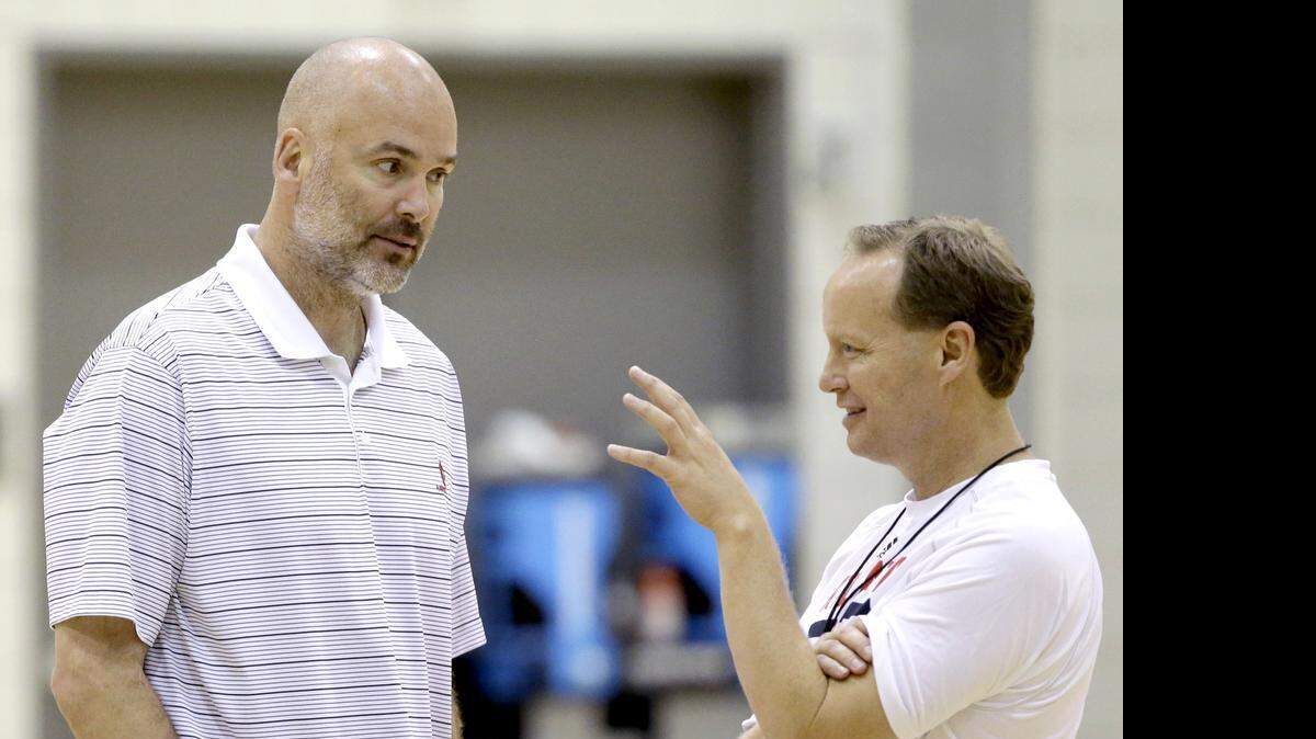 
Danny Ferry, left, is responsible for hiring coach Mike Budenholzer, right, who guided the Hawks to a 60-22 record this season.
