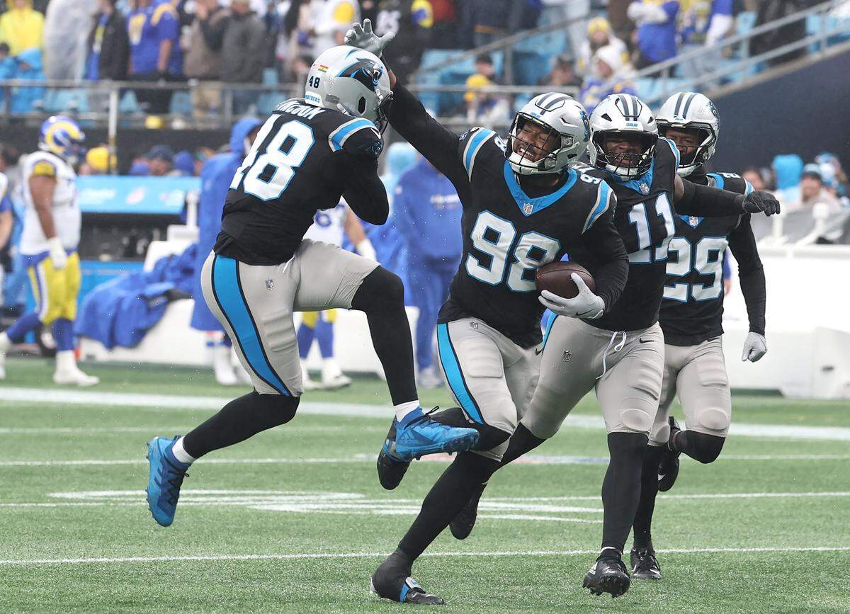 Panthers linebacker D.J. Wonnum, center, celebrates his recovery of a fumble by LA Rams QB Matthew Stafford with his teammates during action on Nov. 30, 2025, at Bank of America Stadium. Panthers defensive tackle Derrick Brown forced the fumble by applying pressure and chasing Stafford from the pocket. The Panthers defeated the Rams 31-28.